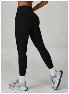 Close-up of black high-waisted yoga pants with butt-lifting seams and slim fit design