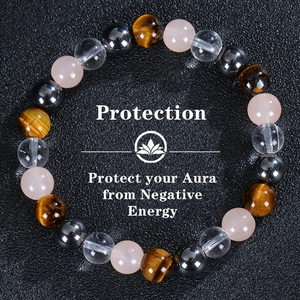 Detail of natural tiger eye and obsidian beads with a lotus logo and protection message