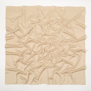 Detailed view of champagne satin square scarf showing soft texture and matte silk-like finish