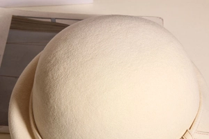 Macro close-up showing the fine wool felt texture of this elegant cream white beret hat