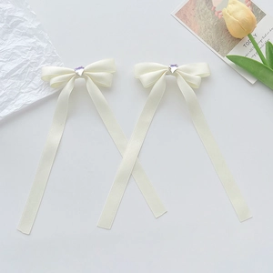 Cream satin ribbon bow hair clips with heart purple crystal in a twin set
