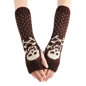 Macro view of knitted fingerless gloves with skull patterns in dark brown yarn
