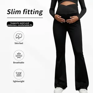 Detail of high-waist crossover belly support band on black flare maternity yoga leggings