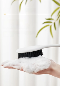 Detailed view of long handle body brush with bamboo charcoal bristles and dense foam