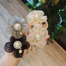 Detail of floral organza hair ties with artificial pearls in grey, beige and black