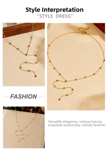 Detail view of dainty gold Y-necklace featuring colorful round gemstone charms and slim chain