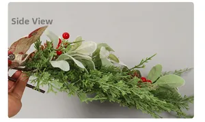 Side view of Christmas pine needle swag with berries, pine cones and burlap truck bow