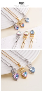 Macro detail of crown heart necklace featuring colorful zircon pendants on stone