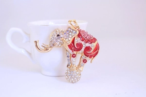 Detailed view of golden elephant keychain with red enamel and sparkling crystal accents