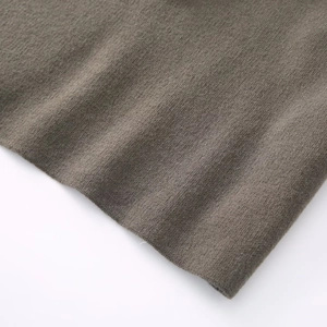 Close-up of soft taupe knit fabric texture showing fine brushed fleece material detail