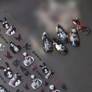 Detail of dark Japanese style nail stickers featuring fox mask and red butterfly motifs