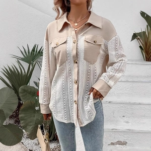 Close-up of elegant beige lace splicing and textured fabric on a long sleeve shirt