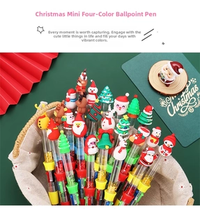 Close-up of Christmas 4-color ballpoint pens with glitter liquid and festive toppers
