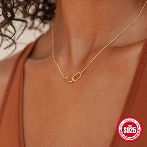Close-up of S925 sterling silver U-shaped double interlocking ring necklace on a model