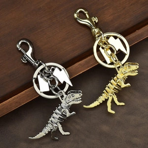 Skeleton dinosaur keychain with lightning charm in silver and gold metal finishes