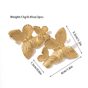 Macro view of vintage 18k gold butterfly earrings with tiger eye stone and radial texture