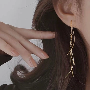 Elegant s925 silver gold tassel drop earrings worn by a model in a minimalist style