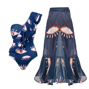 Detail of ruffle one-shoulder swimsuit and sheer wrap skirt with eye pattern print