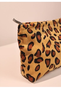 Close-up of leopard print corduroy makeup bag showing fabric texture and metal zipper
