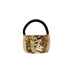 Detail of minimalist golden hammered metal hair cuff with high elastic black rubber band