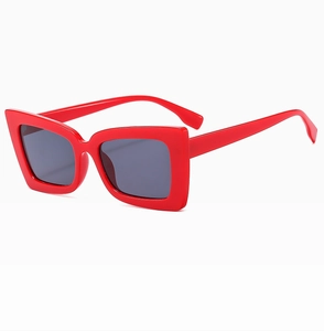 Detail of red oversized square sunglasses frame with dark gray UV protected lenses