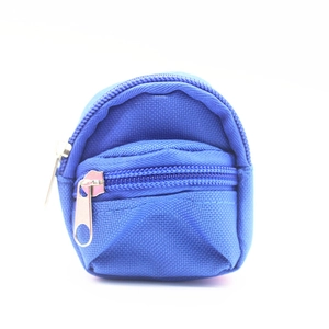 Detail of blue mini backpack coin purse with durable nylon texture and double zippers