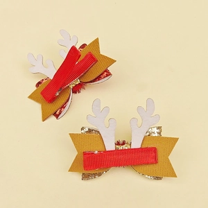 Detail of glitter bow Christmas antler hair clips with red ribbon-wrapped duckbill clips