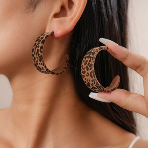 Detail of vintage leopard print flocked C-shape earrings with soft suede texture