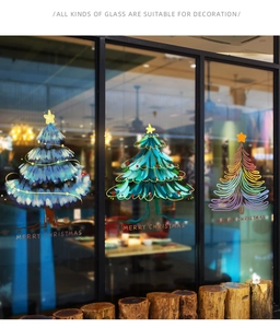 Detail of Christmas tree window stickers with Merry Christmas text on glass shop window