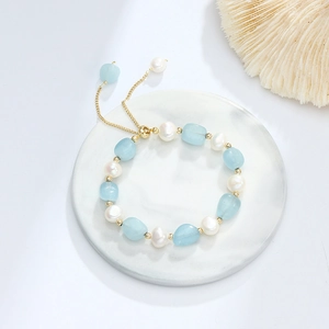 Detail of blue aventurine and pearl bracelet with adjustable golden slider clasp