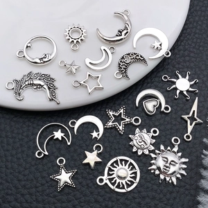 Close-up of vintage silver sun moon and star alloy charms for DIY jewelry making