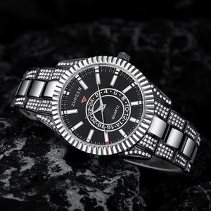 Detail of luxury men's quartz watch with silver steel band and crystals on black dial