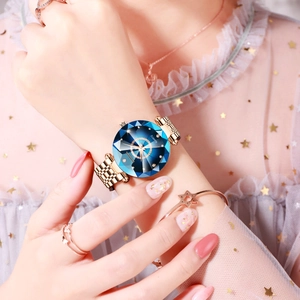 Close-up of elegant ladies watch with blue diamond-cut glass and rose gold strap