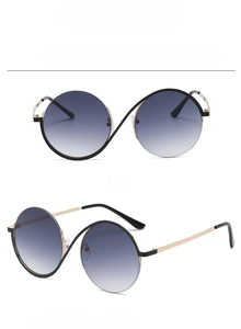 Detail view of round black and gold semi-rimless sunglasses with grey gradient lenses