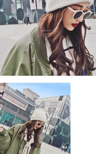 Close-up of white knit beanie paired with a green bomber jacket and sunglasses in street style