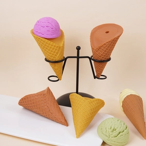 Realistic artificial jumbo ice cream cones with waffle texture on a metal stand