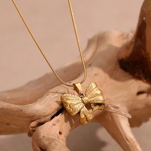 Elegant 18K gold plated stainless steel bow pendant on a fine snake chain necklace