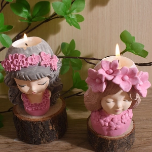 Artistic girl silhouette scented candles with floral crowns on a rustic wooden base