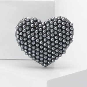 Elegant heart-shaped brooch with grey pearl beads on a white minimalist display stand