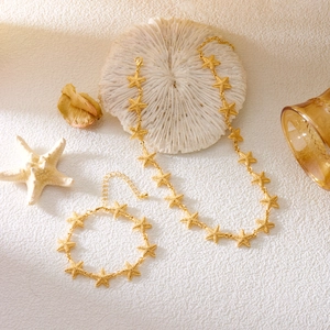 Golden starfish necklace and bracelet set with ocean elements and coral decoration
