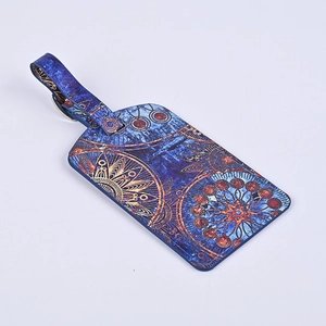 Navy blue luggage tag with golden mandala pattern and a leather texture on white background