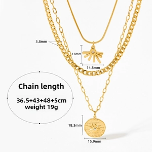 Detail of layered gold sun and coin necklace showing chain widths and pendant dimensions