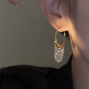 Elegant C-shaped tassel earrings with sparkling rhinestones in a refined gold finish