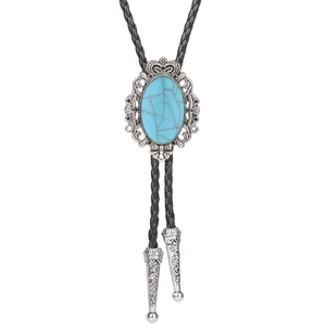 Macro view of silver crown setting with turquoise stone on western bolo tie