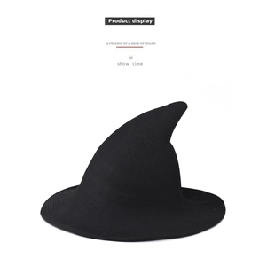Detail shot of black knitted witch hat showing soft fabric texture and pointed brim
