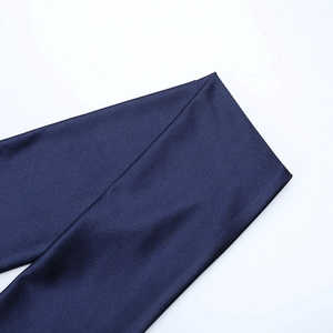 Detailed view of deep blue satin fabric texture and premium glossy finish of the dress