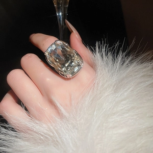Close-up of a luxury cushion cut crystal cocktail ring with silver band for party