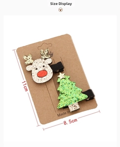 Detailed view of Christmas elk and tree hair clips with dimensions 11cm x 8.5cm on card