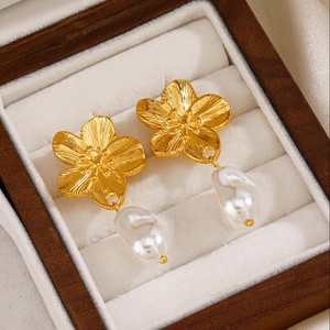 Vintage golden flower earrings with baroque pearls displayed in a premium wooden jewelry box