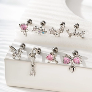 Pink heart and silver bow stud earrings set with zircon stones for a minimalist look